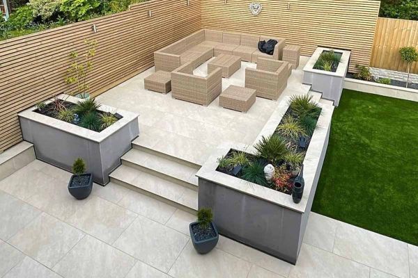 Outdoor seating area with planters, fully paved in White Quartz 1200x600 porcelain tiles.***
