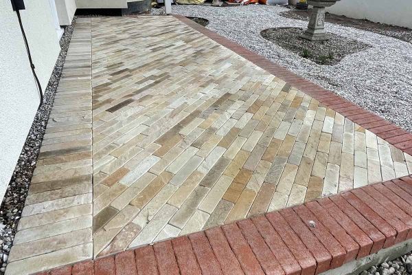 9 Tumbled Mint sandstone pavers, arranged in a herringbone pattern with 5 courses of 2 patio bricks each.***