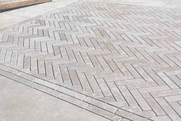 7 Egyptian Beige stone pavers on grey background, showing colour and tumbled edges. Free UK delivery available.***