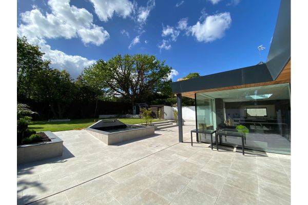 Spacious garden design using Heritage Chalk 900x600 Patio Tiles, with linear layout and matching modern raised planters.***