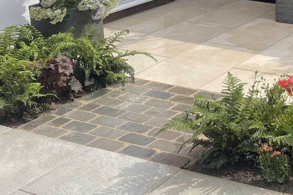 2 sizes of tumbled Kandla Grey sandstone setts against white background to show colour and proportion. Free UK delivery available.***
