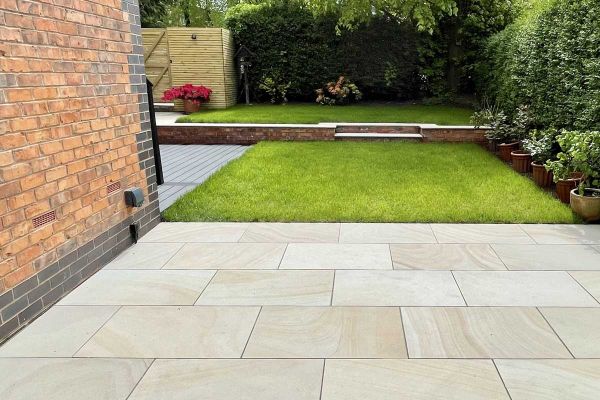A slab of Light Buff sawn sandstone paving, seen from above, showing colours, markings and texture. Free UK delivery available.***